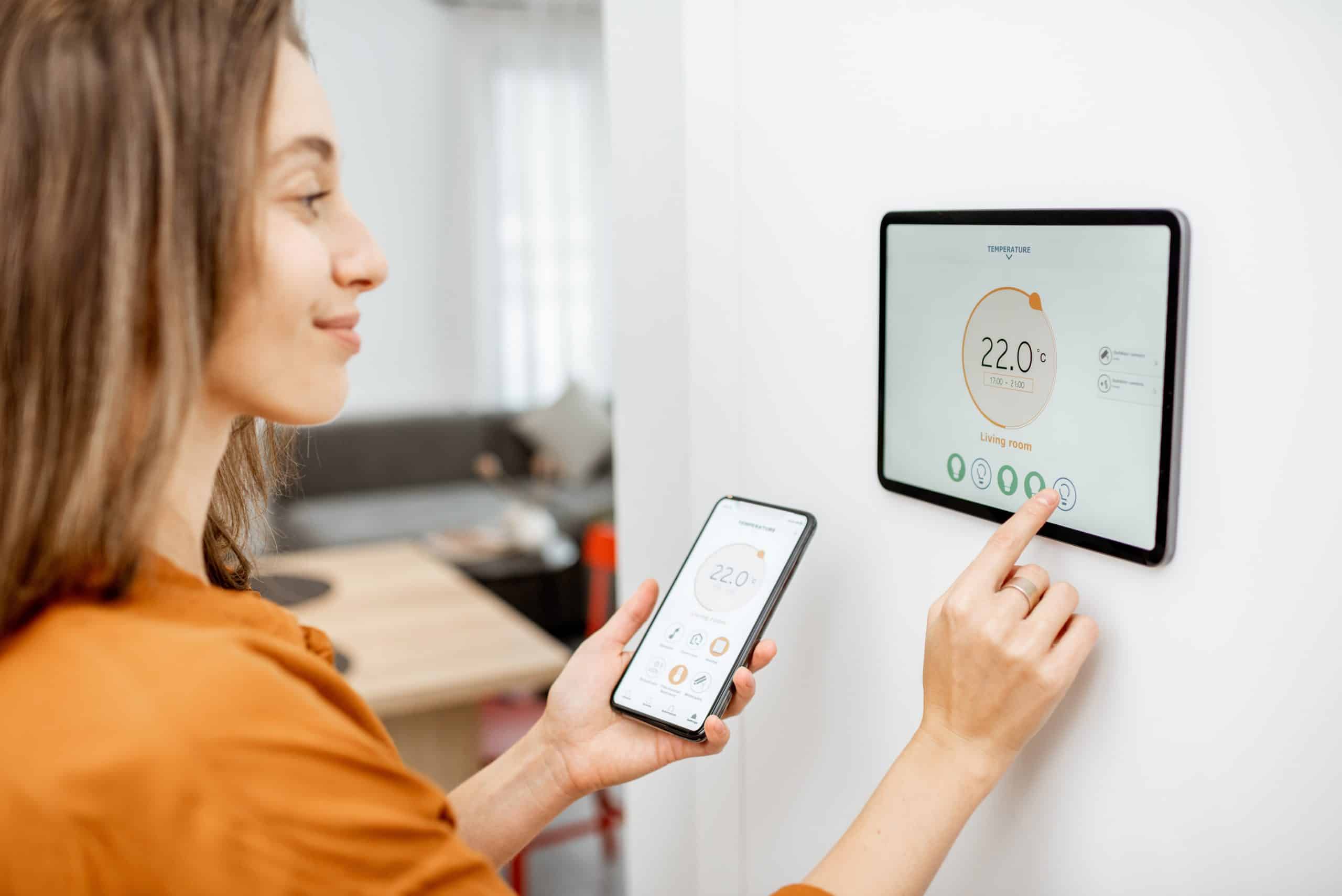 Woman controlling heating with a smart devices